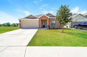 New Braunfels house for rent - A brick house with a tree in front of it.