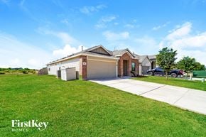 New Braunfels house for rent - A house with a garage and a driveway in front of it.