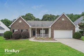 Huntersville house for rent - a home with a lawn and a white garage door