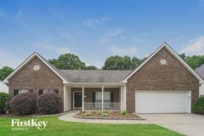 Huntersville house for rent - a brick house with a porch and a white garage door