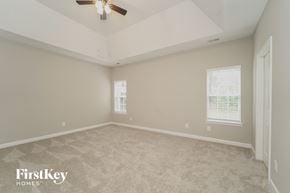 Huntersville house for rent - a bedroom with carpet and a ceiling fan