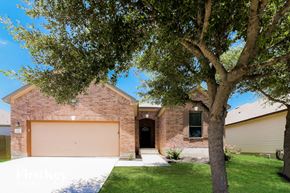 Live Oak house for rent - a garage door in front of a brick house