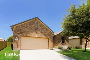 Live Oak house for rent - a garage door in front of a brick house