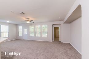 Live Oak house for rent - an empty living room with a ceiling fan and a window