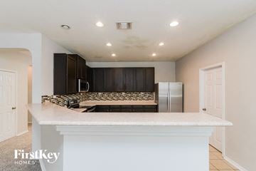Live Oak house for rent - a kitchen with a counter top and a refrigerator