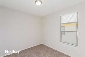 Live Oak house for rent - a bedroom with a window and a carpeted floor