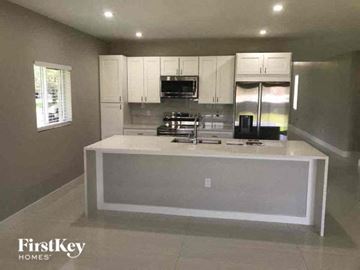 Lehigh Acres house for rent - a kitchen with a large island in the middle