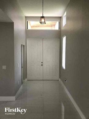 Lehigh Acres house for rent - a hallway with a white door and a ceiling light