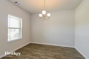Anahuac house for rent - A room with wooden flooring and a chandelier hanging from the ceiling.