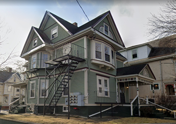 Somerville apartment for rent - a green house with a ladder on the side of it