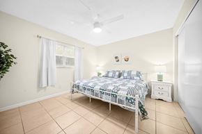 Jensen Beach apartment for rent - a bedroom with a bed and a ceiling fan