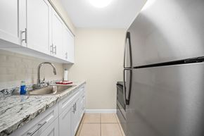 Jensen Beach apartment for rent - a kitchen with white cabinets and a stainless steel refrigerator