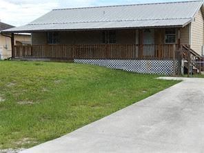 Leigh Acres house for rent - a house with a yard and a sidewalk in front of it