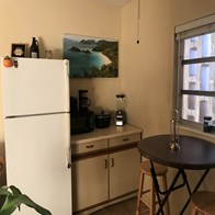 Fort Myers house for rent - a kitchen with a small table and a refrigerator