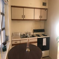Fort Myers house for rent - a kitchen with a table and a stove and a sink