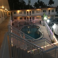 Fort Myers house for rent - a hotel balcony with a swimming pool at night