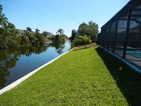 Cape Coral house for rent - a grassy area next to a body of water