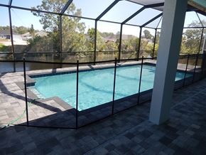 Cape Coral house for rent - a swimming pool in a house with a screened in pool