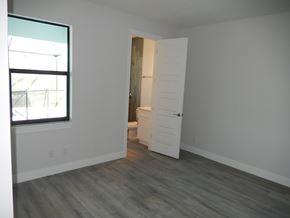 Cape Coral house for rent - an empty bedroom with an open door to the bathroom