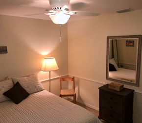 Fort Myers house for rent - a bedroom with a bed and a mirror