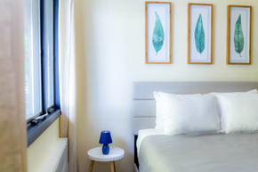 Greenwood Lake apartment for rent - a small bedroom with a bed and two paintings on the wall