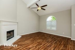 Fort Worth house for rent - A room with a fireplace and a ceiling fan.