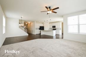 Avon house for rent - an empty living room and kitchen with a ceiling fan