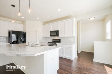 Avon house for rent - a kitchen with white cabinets and a white counter top
