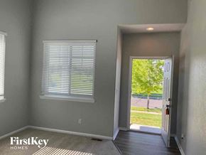 Commerce City house for rent - A room with a door leading to a backyard.
