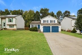 Columbus house for rent - a white house with a blue garage door