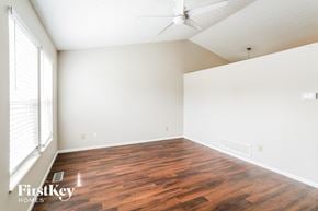 Columbus house for rent - the spacious living room with wood flooring and a ceiling fan