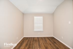 Fate house for rent - the living room of a home with wood floors and a window