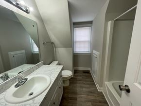 Wilson apartment for rent - A bathroom with a sink, toilet, and bathtub.