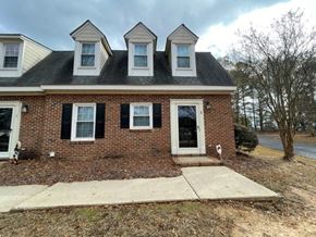 Wilson apartment for rent - A brick house with a black roof and white trim.