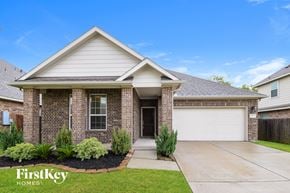Baytown house for rent - A house with a garage and a driveway in front.