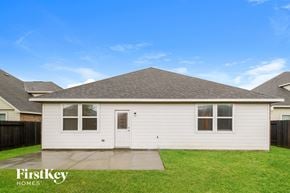 Baytown house for rent - A house with a white exterior and a brown roof is for sale.