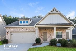 Dallas house for rent - a brick house with a gray door and a white garage door