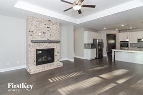 Dallas house for rent - a living room with a fireplace and a kitchen