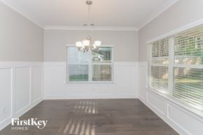 Dallas house for rent - a dining room with two windows and a chandelier