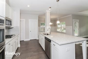 Dallas house for rent - a large kitchen with white cabinets and a white counter top