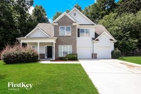 Fayetteville house for rent - a white house with a lawn and a driveway