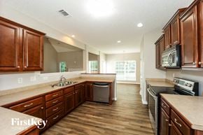 Fayetteville house for rent - a kitchen with wooden cabinets and stainless steel appliances