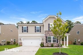 Goose Creek house for rent - a beige and brick house with a white garage door