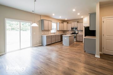 Goose Creek house for rent - an open kitchen and living room with wood floors and stainless steel appliances