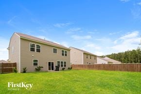 Goose Creek house for rent - a group of houses with a grassy yard and a fence