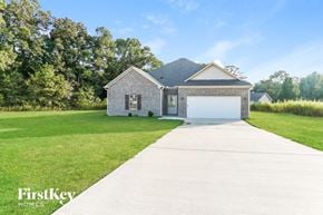 Jasper house for rent - a brick house with a white garage door and a lawn