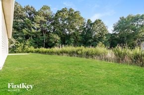 Jasper house for rent - a large lawn with trees in the background