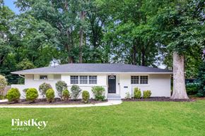 Charlotte house for rent - a white house with a tree in front of it
