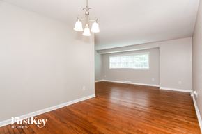 Charlotte house for rent - an empty living room with wood flooring and a window