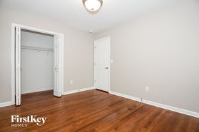 Charlotte house for rent - a bedroom with wood flooring and a closet